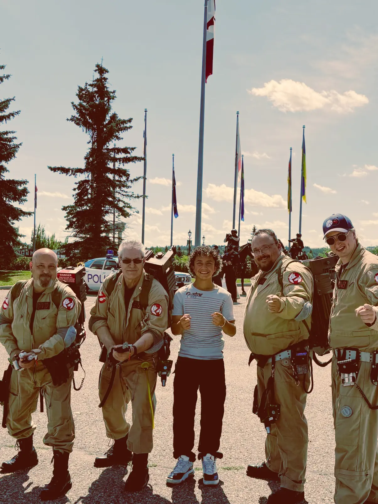 Ghostbusters costumed group with Canadian flag and police car
