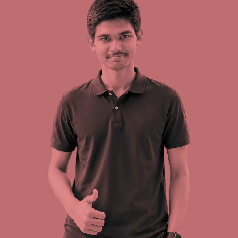 Young man in a dark polo shirt gives a thumbs up gesture against a flat red background.