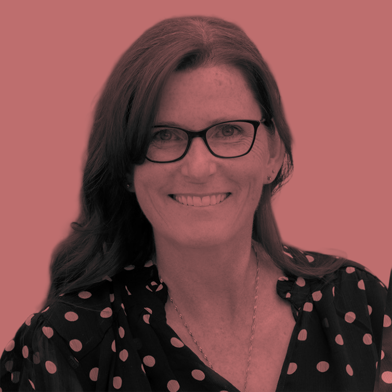 Canadian woman with glasses and polka dot shirt smiling