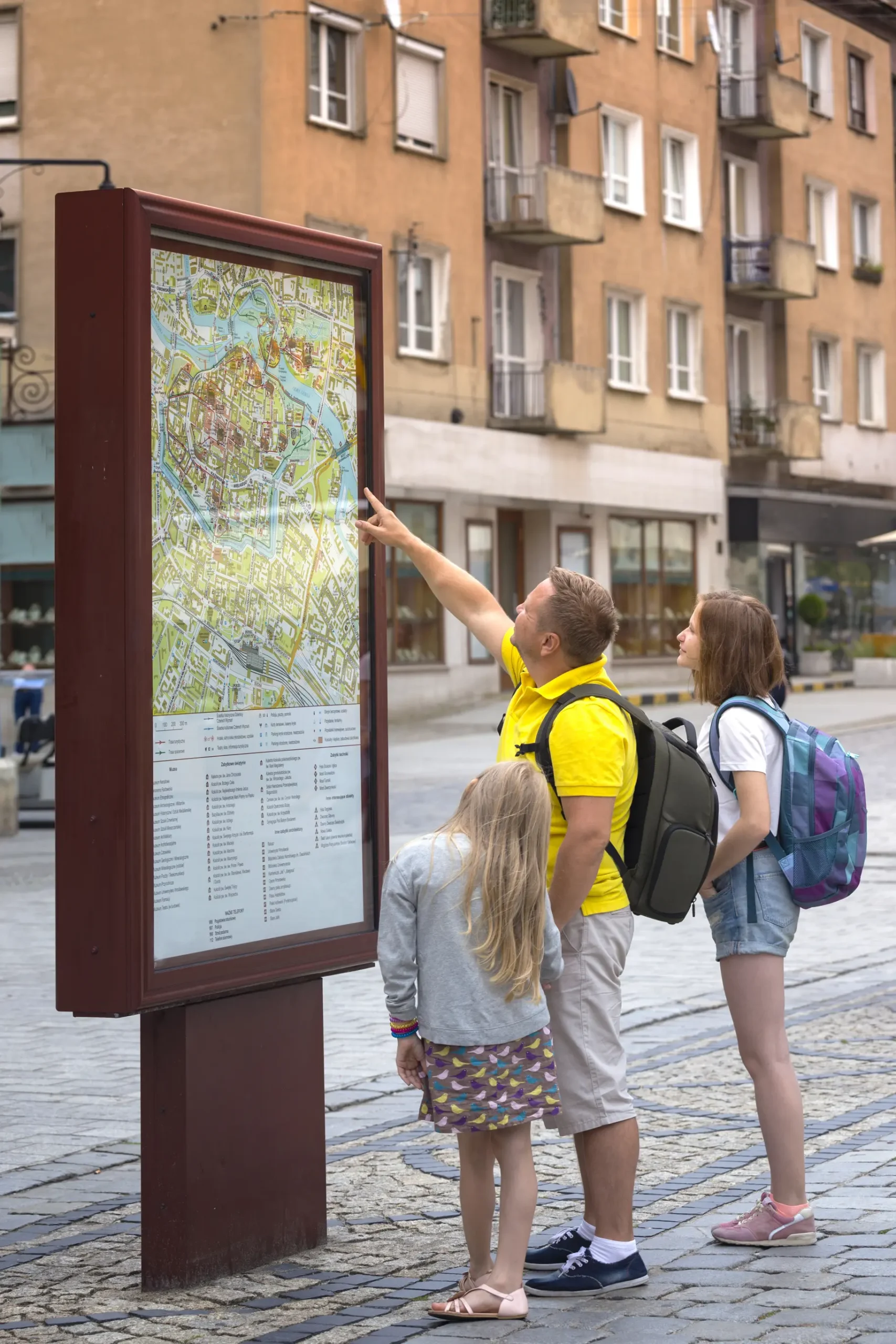 family-examining-city-map-on-a-european-street-2026-01-11-08-33-16-utc