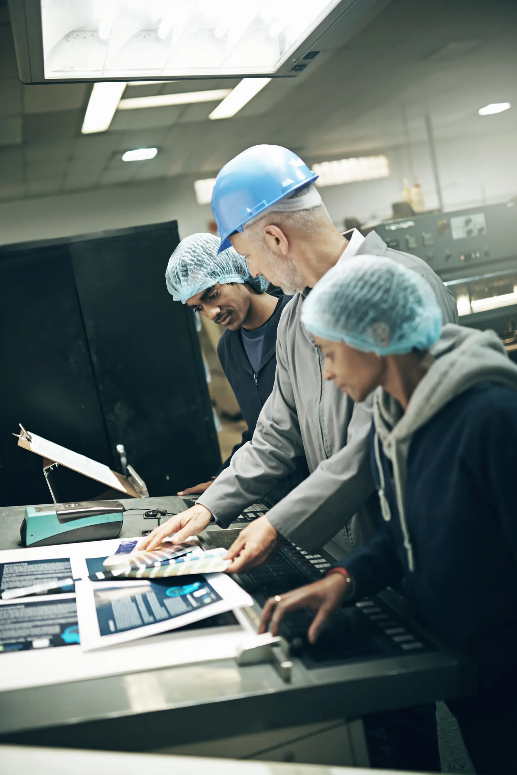 production-team-analyzing-printed-materials-in-fac-2026-01-09-09-53-34-utc