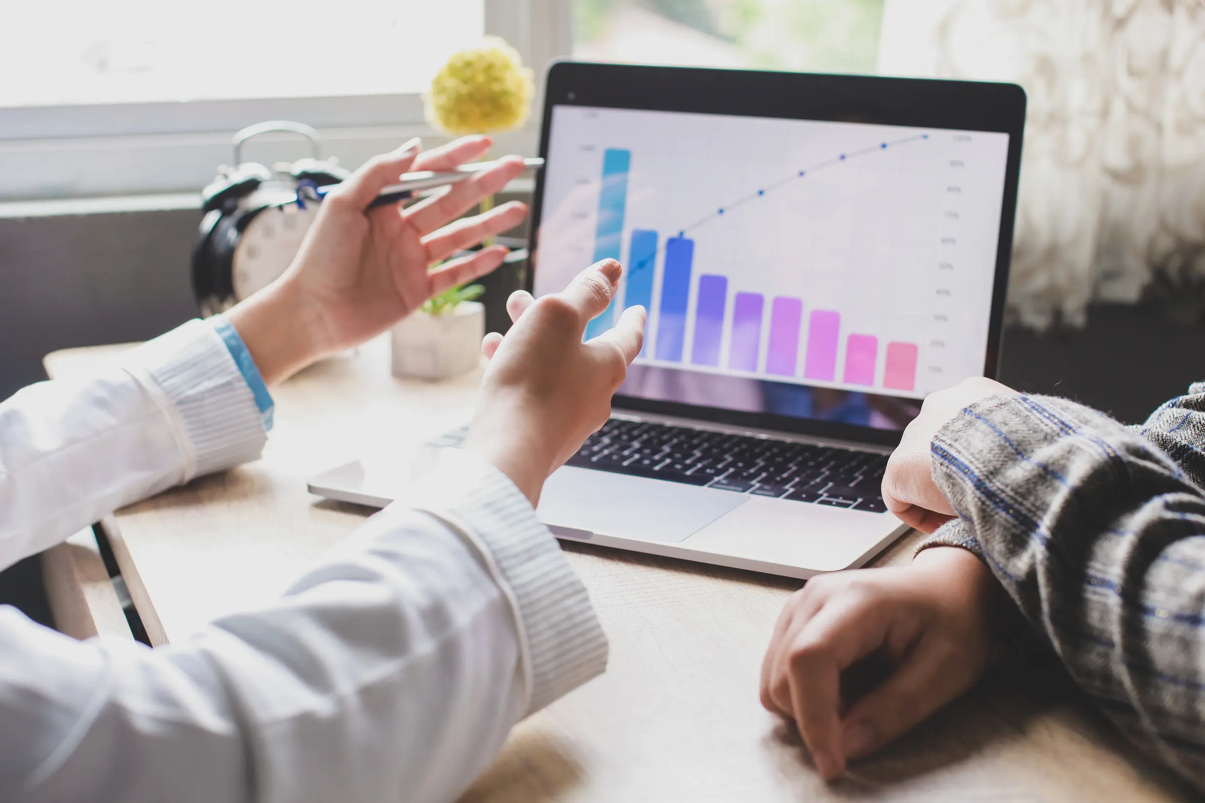 professionals-reviewing-a-graph-on-laptop-at-desk-2026-03-18-04-24-58-utc