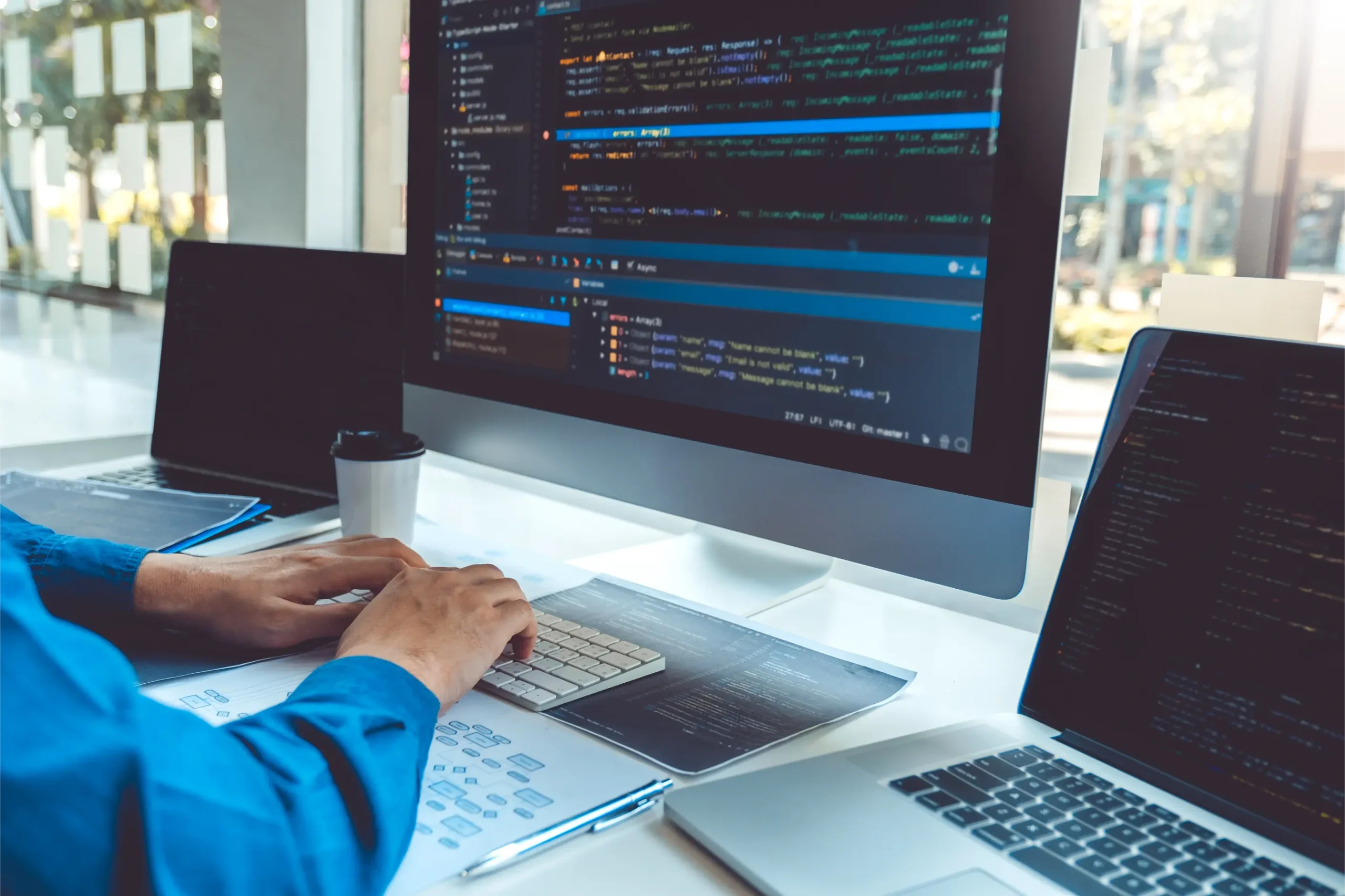 software-developer-coding-at-desk-with-multiple-mo-2026-01-06-10-44-40-utc
